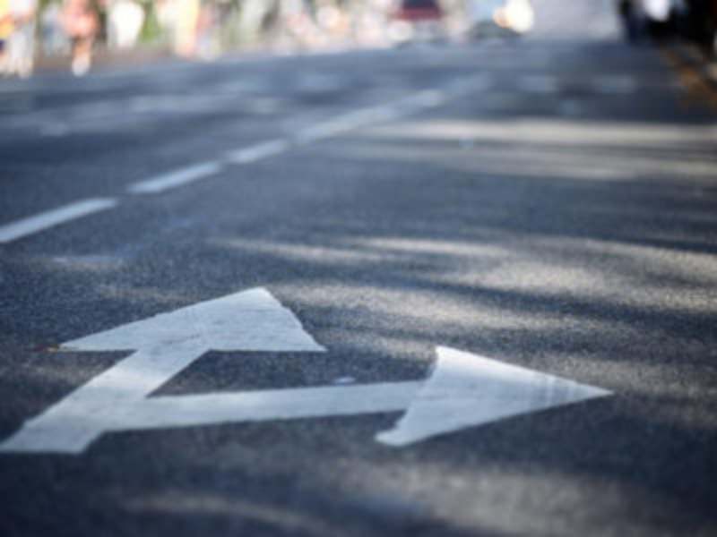 Arrows on a road, one pointing straight, one pointing right