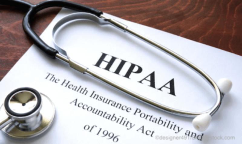 Paper with HIPAA on it sitting on a table with a stethoscope
