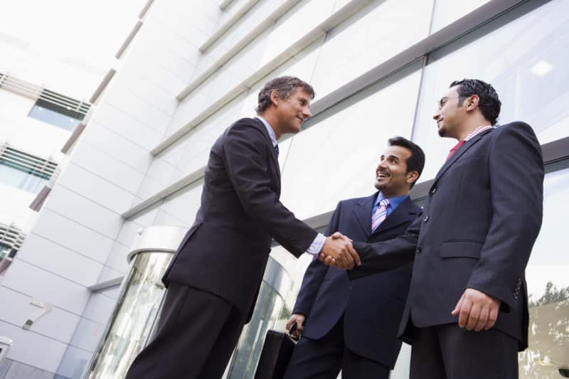 businessman shaking hands with another businessman