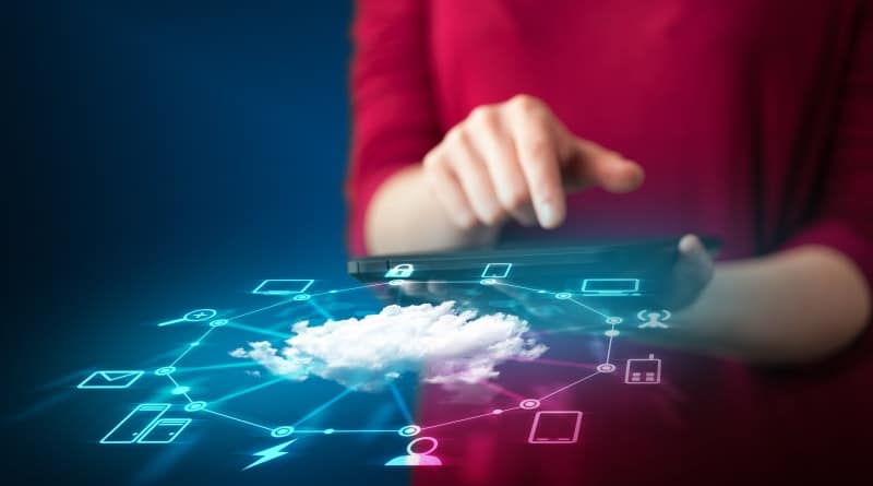 Person holding a tablet with image of a cloud in foreground