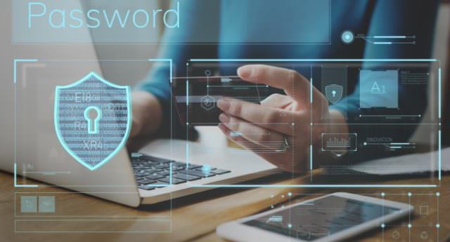 Person at laptop with credit card with a padlock icon in foreground