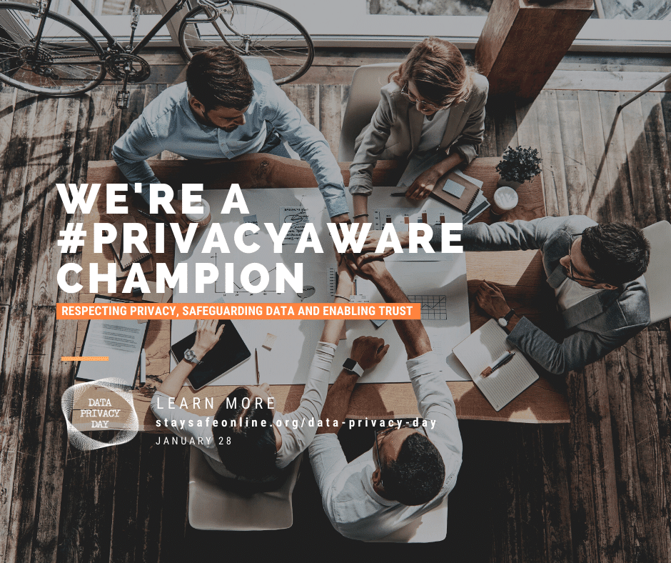 Office team sitting around a table working with text that says "We're a #PrivacyWare Champion"