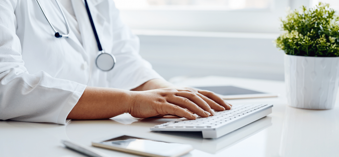 A doctor working on a keyboard